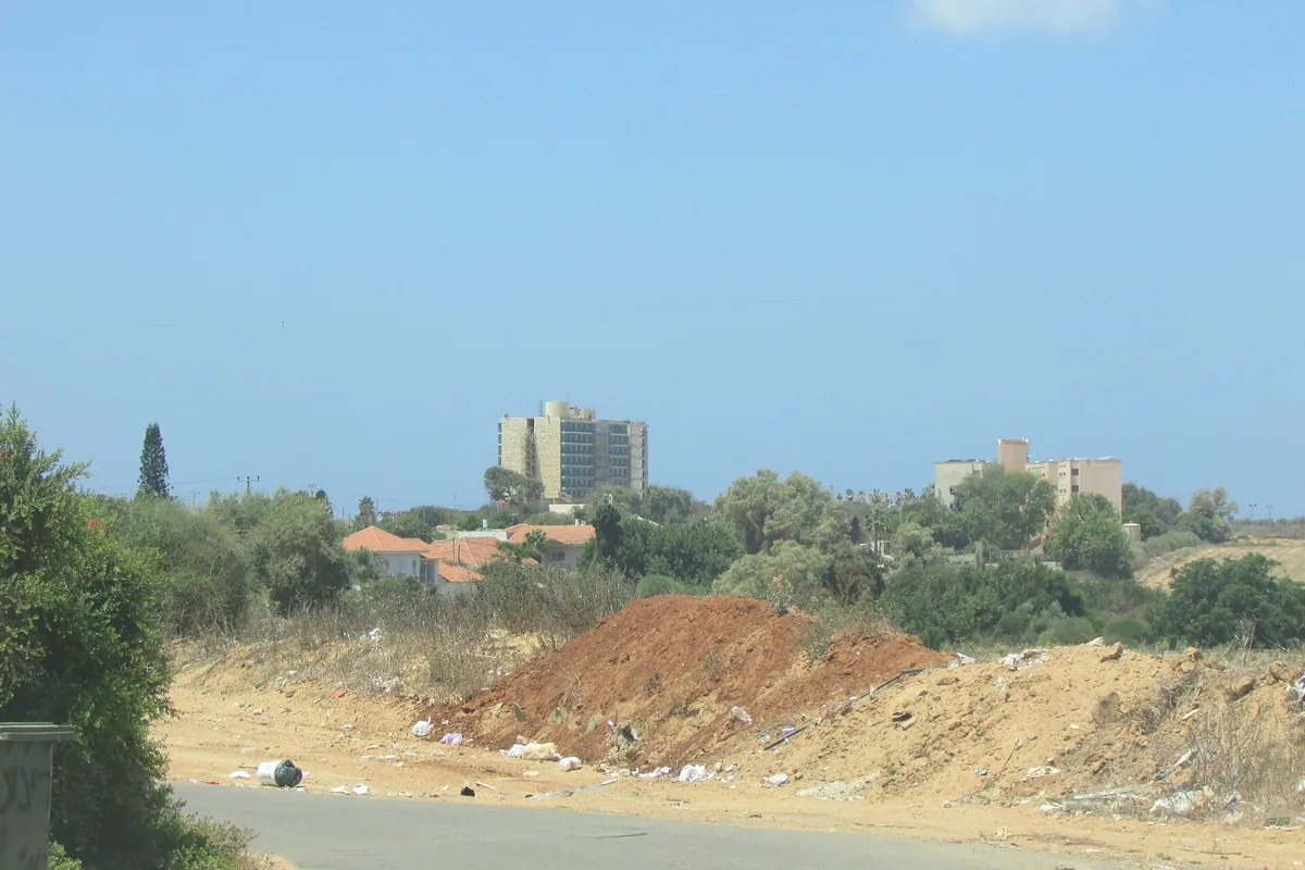 Red-roofed houses of Ein HaTchelet with the Amigur retirement home tower behind